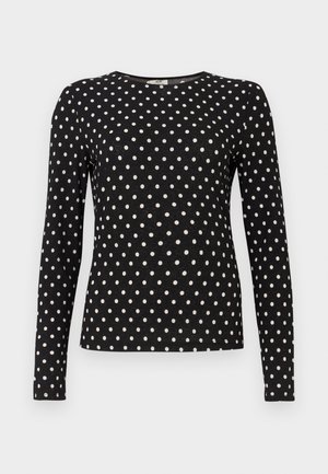 Black long-sleeve top with white polka dots, round neckline, and textured fabric. Provides a fitted silhouette, suitable for casual wear.
