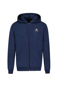 Sudadera con cremallera de color azul marino hecha de material suave; cuenta con dos bolsillos frontales, capucha con cordón y un logo en el lado izquierdo del pecho.