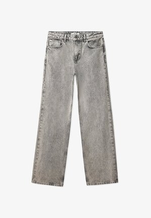 Heledad hallis kõrge vöökohaga teksad, lõdva istumisega, sirged sääred, kerge fadeering ja viis taskut. Valmistatud denimist, millel on nähtavad õmblused.