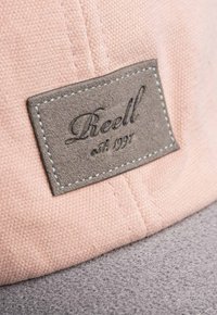 Pink fabric cap with a gray textured brim, featuring a stitched gray leather patch with "Liveell est. 1991" embossed.