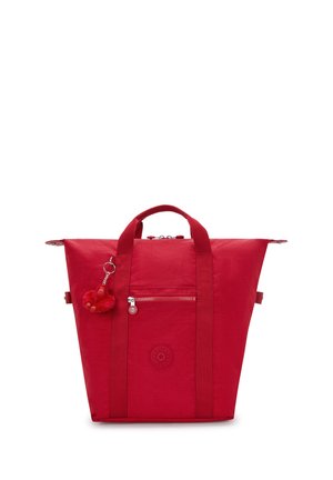 Red tote bag with dual top handles, front zip pocket, and a small red monkey keychain attached to one handle.
