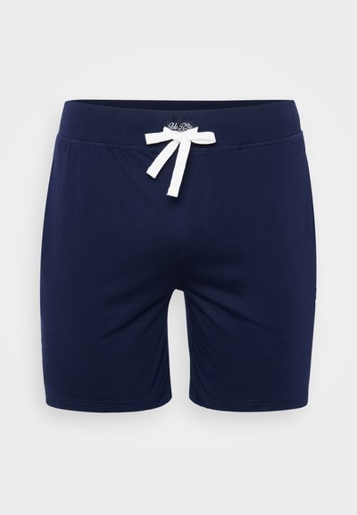 Navyblå svømmebukser i blødt stof, med en hvid snor og et logo-patch på venstre ben. Lige snit med en behagelig linning.
