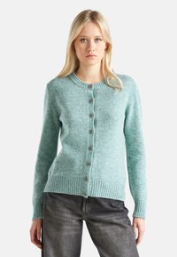 Jasnoniebieski kardigan wykonany z teksturowanej dzianiny, z okrągłym dekoltem, zapięciem na guziki oraz prążkowanymi mankietami i dolnym brzegiem.