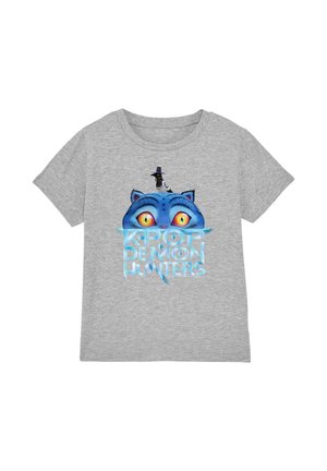 Gray T-shirt with a blue cat's face and yellow eyes peeking above "K-Pop Demon Hunters" text, topped by a small black bird wearing a hat.