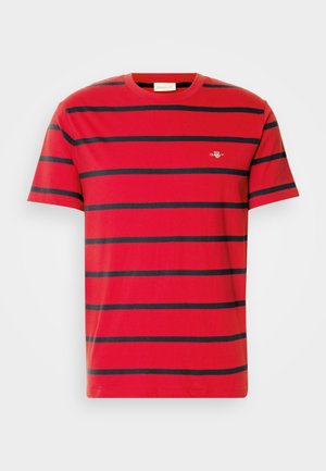 Red cotton t-shirt featuring horizontal navy stripes, a crew neckline, and a small embroidered logo on the chest. Classic fit design.