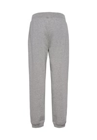 Grå joggingbukser lavet af blødt stof, med et smalnet bendesign, elastisk talje og ribstrikkede manchetter ved anklen.