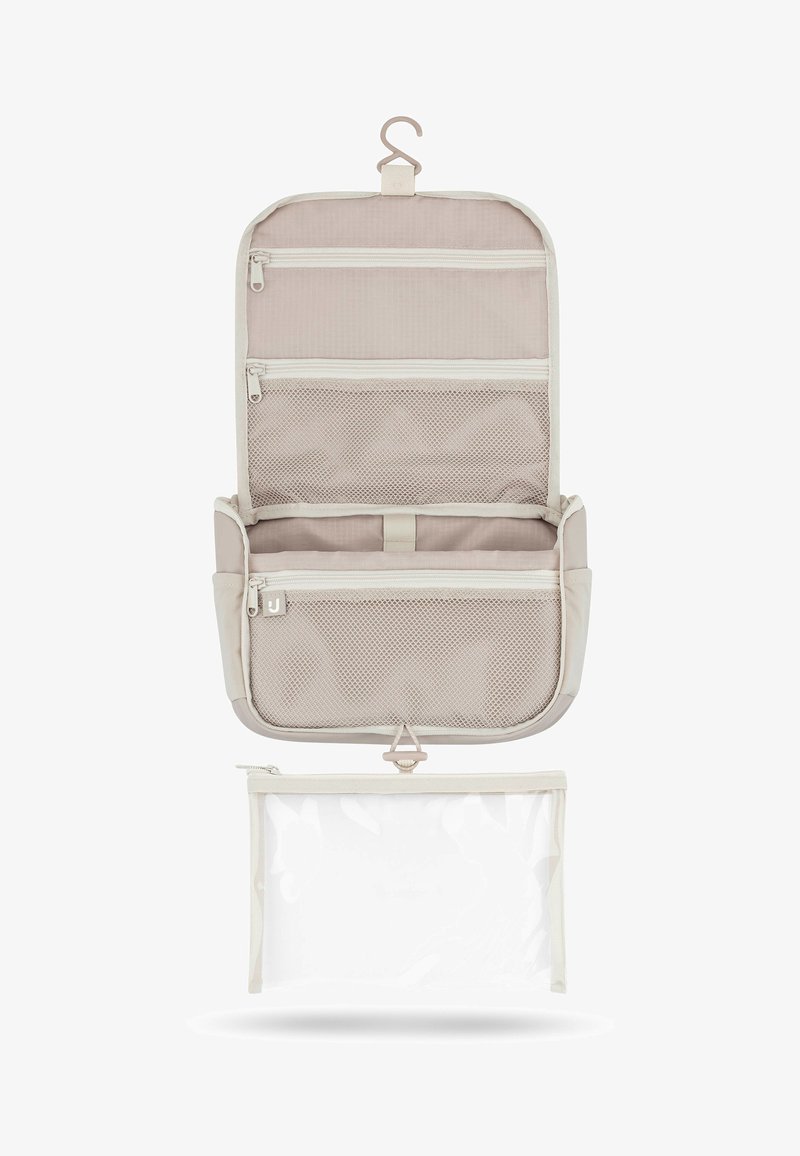 Borsa da toilette beige da appendere con più scomparti in rete con cerniera e una pochette in plastica trasparente staccabile sotto.