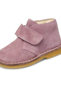Scarpa per bambini in camoscio viola con cintura in Velcro e suola in gomma marrone, veduta ravvicinata che mostra le cuciture e la texture.