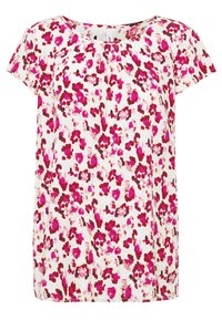 Blouse blanche à manches courtes avec col rond et motif floral abstrait en rose, magenta et marron uniformément réparti sur le tissu.