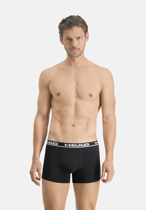 Schwarze Boxershorts aus Baumwolle mit einem weißen Markenbund. Das Design zeichnet sich durch eine enganliegende Passform und einen minimalistischen Stil ohne Muster aus.
