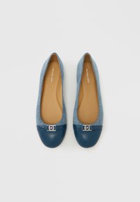 Bailarinas de mezclilla con punta redonda y puntera de cuero azul marino. Presentan un adorno plateado con el logo MK en la parte delantera y una plantilla beige.