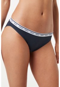 Granatowy bawełniany bikini z białą elastyczną talią z logo "next". Smukły design, umiarkowane pokrycie i gładka tekstura.