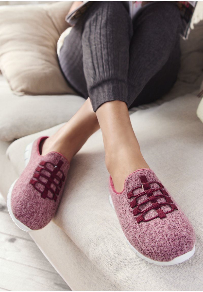Maroon slip-on shoes with a textured knitted upper, featuring elastic bands across the top and a white rubber sole.