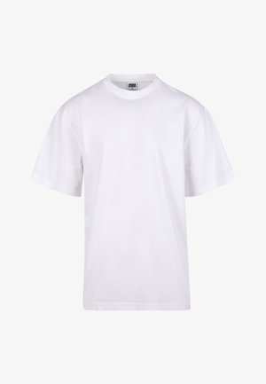 Camiseta blanca de algodón con cuello redondo, mangas cortas y un corte relajado. Presenta un diseño liso sin patrones ni detalles.