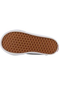 Suela de zapato de goma con un patrón de miel en forma de panal texturizado, bordeado por goma blanca. Presenta bordes planos y un diseño de punta redondeada.