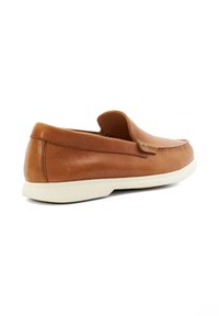 Brown leather slip-on shoes with a smooth texture, white rubber sole, and decorative stitching along the upper edge. Rounded toe design.