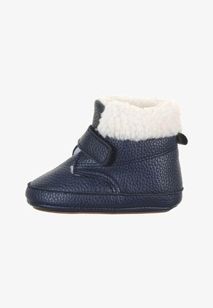 Chausson bébé texturé bleu marine avec doublure en polaire blanche et une bride velcro pour une fixation facile, vu de côté.