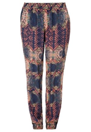 Pantalon ample avec taille et poignets élastiques, présentant un motif géométrique et floral multicolore en tons marine, rose et vert.