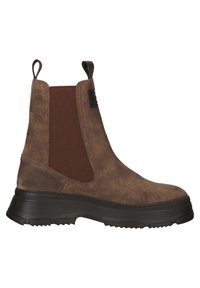 Botte Chelsea en daim marron avec panneaux élastiques sur les côtés, semelle épaisse noire et languettes de tirage sur le col de la cheville.