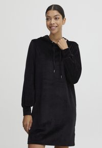 Schwarzes Kapuzenkleid aus weichem Samtmaterial. Verfügt über lange Ärmel mit einem engen Abschluss, eine verstellbare Kordelzugkapuze und eine lockere Silhouette.