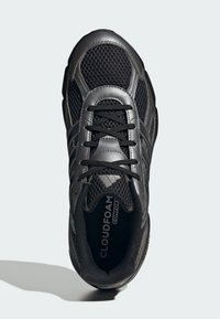 Čierna športová topánka s vrchnou časťou z textilu, koženými detailami, textúrovanými šnúrkami a vypolstrovaným golierom, označená nápisom "CLOUDFOAM Comfort" na vnútornej strane.