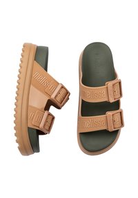 Sandali color sabbia con doppie cinghie regolabili, realizzati in materiale gommoso, superficie texturizzata e suola verde con battistrada pronunciato.