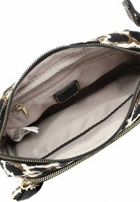 Pochette con zip caratterizzata da una stampa leopardata su materiale canvas, cerniera nera e un interno in tessuto beige con una piccola tasca con zip.