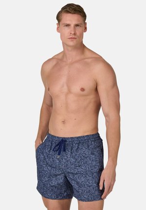 Dunkelblaue Badeshorts mit einem weißen Blättermuster, aus leichtem Stoff gefertigt. Verfügt über einen elastischen Bund mit Kordelzug und Seitentaschen.