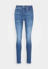 High-waisted, skinny jeans in medium blue denim, featuring a button closure, five pockets, and a minimalistic design with slight fading.