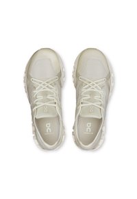 Light beige athletic shoes with a mesh upper, flat laces, and cushioned sole. Features logo and model name on the sides and insoles.