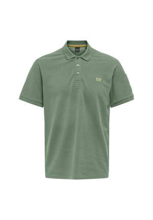 Polo shirt in muted green cotton, featuring a collared neck, three-button placket, and a stitched label on the chest. Short sleeves.