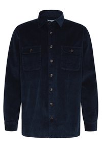 Camisa de pana en color azul marino con cuello abotonado, dos bolsillos en el pecho y botones marrones. Presenta una textura de canalé vertical.