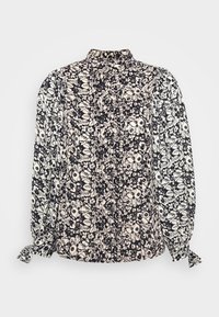Blouse florale noir et blanc avec col montant, manches longues et poignets froncés. Présente un motif texturé avec des feuilles et des fleurs sur toute la surface.