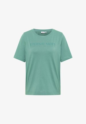 T-shirt vert à manches courtes avec col ras du cou, portant le texte "CIEUX ÉTERNELS" imprimé sur la poitrine dans une police verte assortie.