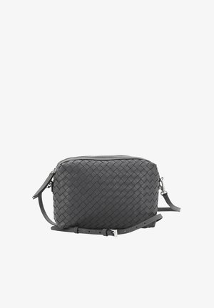 Black woven leather crossbody bag with a zip closure, adjustable strap, and a smooth texture. Rectangular shape with fine detailing.