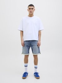 White oversized T-shirt, light blue denim shorts, blue sneakers, and white socks with blue stripes. Simple design, casual fit.