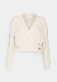 Krémově zbarvený pletený zavinovací svetr s výstřihem do V, dlouhými rukávy a zavázáním v pase. Texturovaná látka ve stylu crop topu.