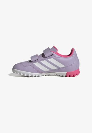 Zapatilla deportiva morada con rayas blancas, forro interior rosa, correas de velcro y suela texturizada blanca y rosa para tracción.
