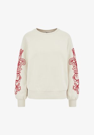 Kreemist kangast särgiga pullover, millel on punane lilleline tikand varrukatel, soonikkoes käised ja ümar kaelus. Valmistatud pehmest, tekstuuriga kangast.