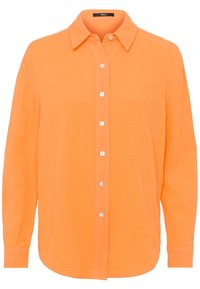 Chemise boutonnée orange en tissu texturé. Dotée d'un col, de manches longues et de boutons blancs le long de la patte de boutonnage.