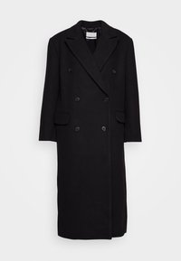 Abrigo negro de doble botonadura con cuello con muescas, mangas largas, bolsillos laterales y tejido texturizado. Equipado con botones negros.