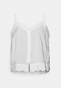 Vit lättviktsbandeau med vågiga kanter, justerbara axelband och knappstängning framtill. Strukturerad tyg med mjukt avslut.