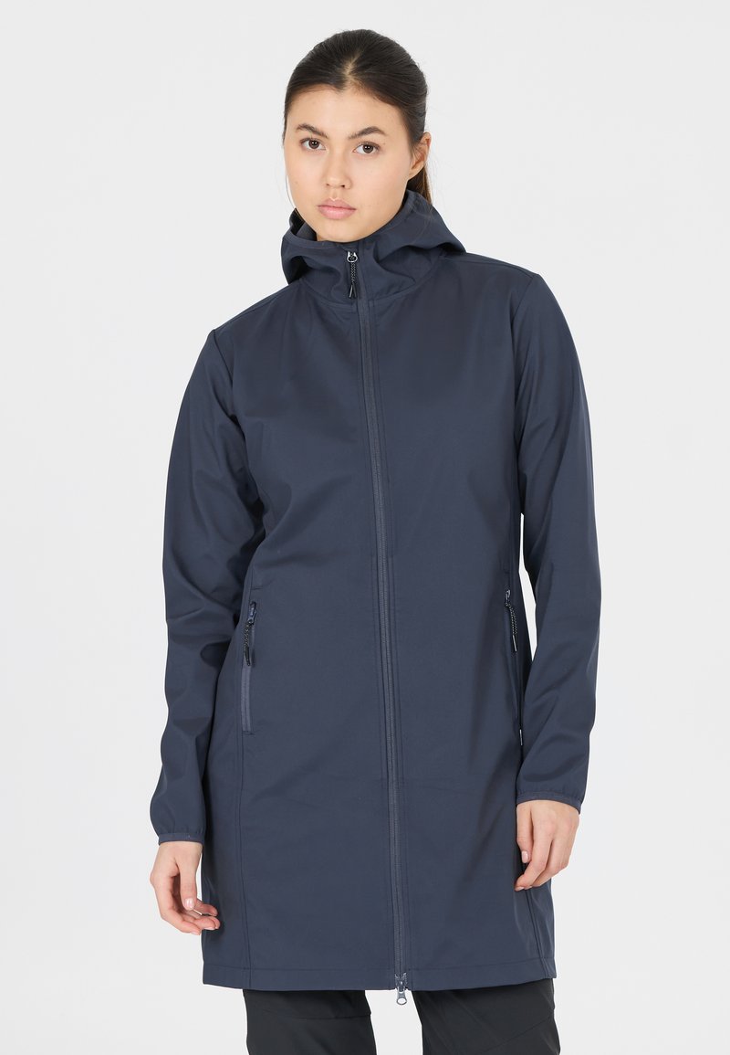 Marinblå softshell-jacka med huva, framdragkedja och två sidofickor med dragkedja. Långa ärmar och en strömlinjeformad design med mjuk textur.