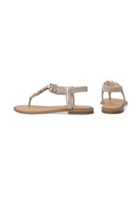 Flade sandaler med metalliske sølvremme dekoreret med dekorative sten, med en polstret sål og et minimalistisk design.
