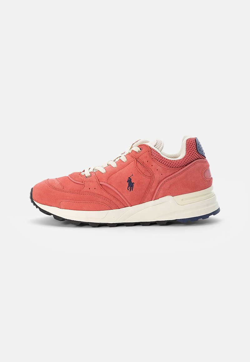 Coral suede sneaker with off-white laces and sole, black logo of a horse and rider on the side, and black and navy textured outsole.
