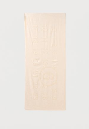 Serviette rectangulaire beige clair avec des chiffres en relief de 0 à 25 disposés en rangées et un grand chiffre 9 encerclé au centre.