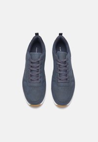 Navy blue sneakers with smooth synthetic material, round toe, and lace-up design. Features perforations for breathability and a white rubber sole.