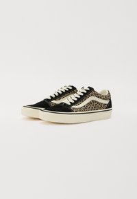 Black and leopard-print sneakers with suede and canvas material. Features white laces and a textured rubber sole. Rounded toe design.