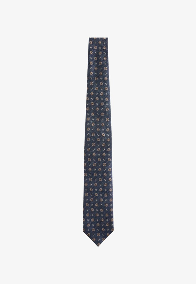 Cravatta blu navy con un motivo circolare ripetuto in tonalità di arancione chiaro e crema, realizzata in tessuto morbido con una punta affusolata.