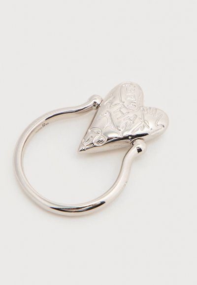 Ασημένιο δαχτυλίδι με ανοιχτή μπάντα και καρδιά ως κόσμημα, χαραγμένη με αφηρημένα σχέδια και υφασμένους μοτίβους.